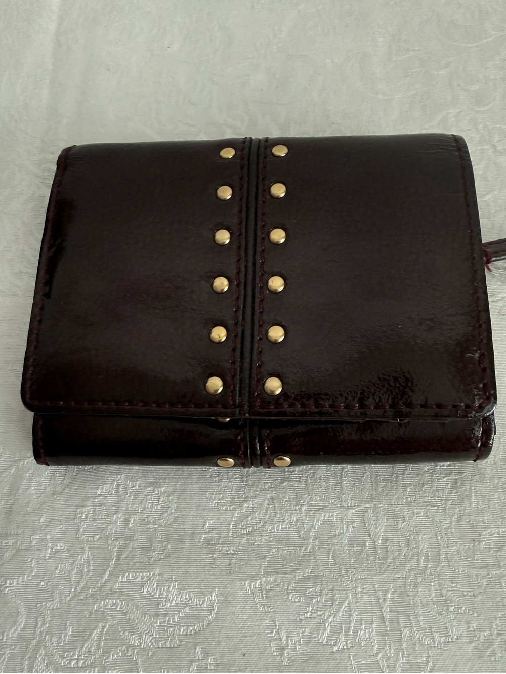 Michael Kors Burgundy patent bifold wallet with Gold Studs